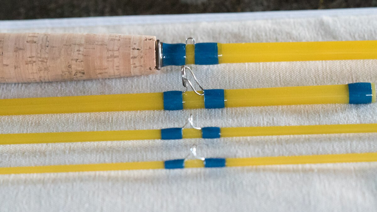 Blue halo fiberglass rod. YLI natural silk thread. Thinned epoxy